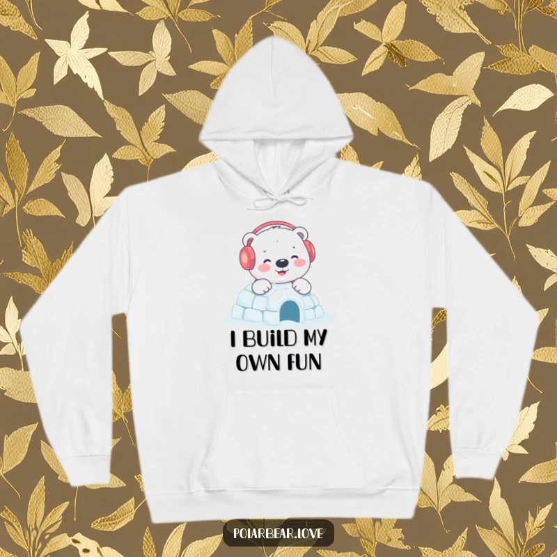 Funny polar bear igloo hoodie showcasing a content bear with earmuffs building a sparkling igloo, perfect for staying warm and cheerful.